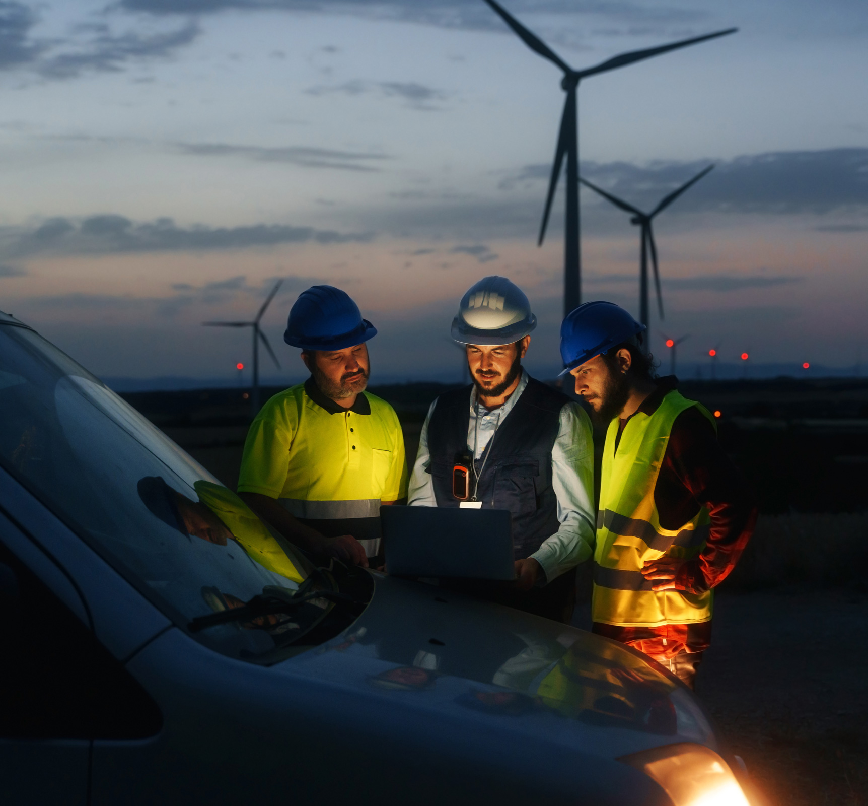 Technicians working in the field at a wind farm